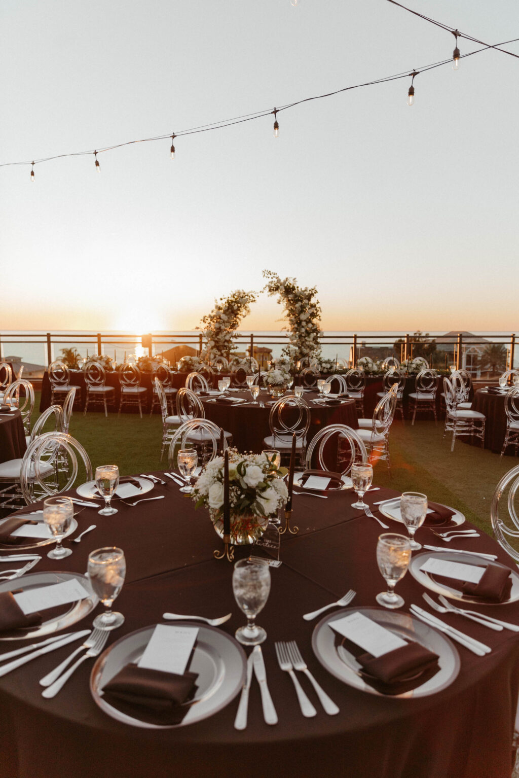 Elegant Rooftop Wedding Reception with Black Linen and Clear Acrylic Infiniti Ghost Chairs with Bistro Lighting Ideas | Rentals Outside the Box Rentals | St. Petersburg Hotel Wedding Hotel Zamora
