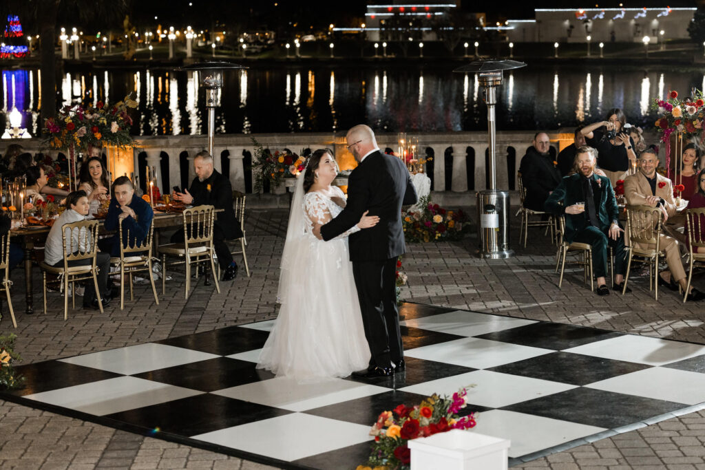 Bride and Groom First Dance | Black and White Checkered Dance Floor | Gold Napoleon Chairs | Tampa Bay Kate Ryan Event Rentals | A Chair Affair