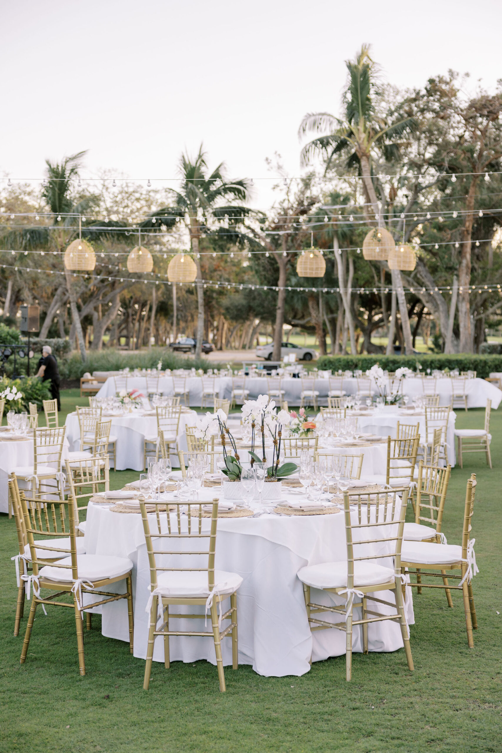 Elegant Tropical White Outdoor Wedding Reception with Gold Chiavari Chairs and Rattan Hanging Lanterns Inspiration | Sarasota Wedding Venue The Resort at Longboat Key Club