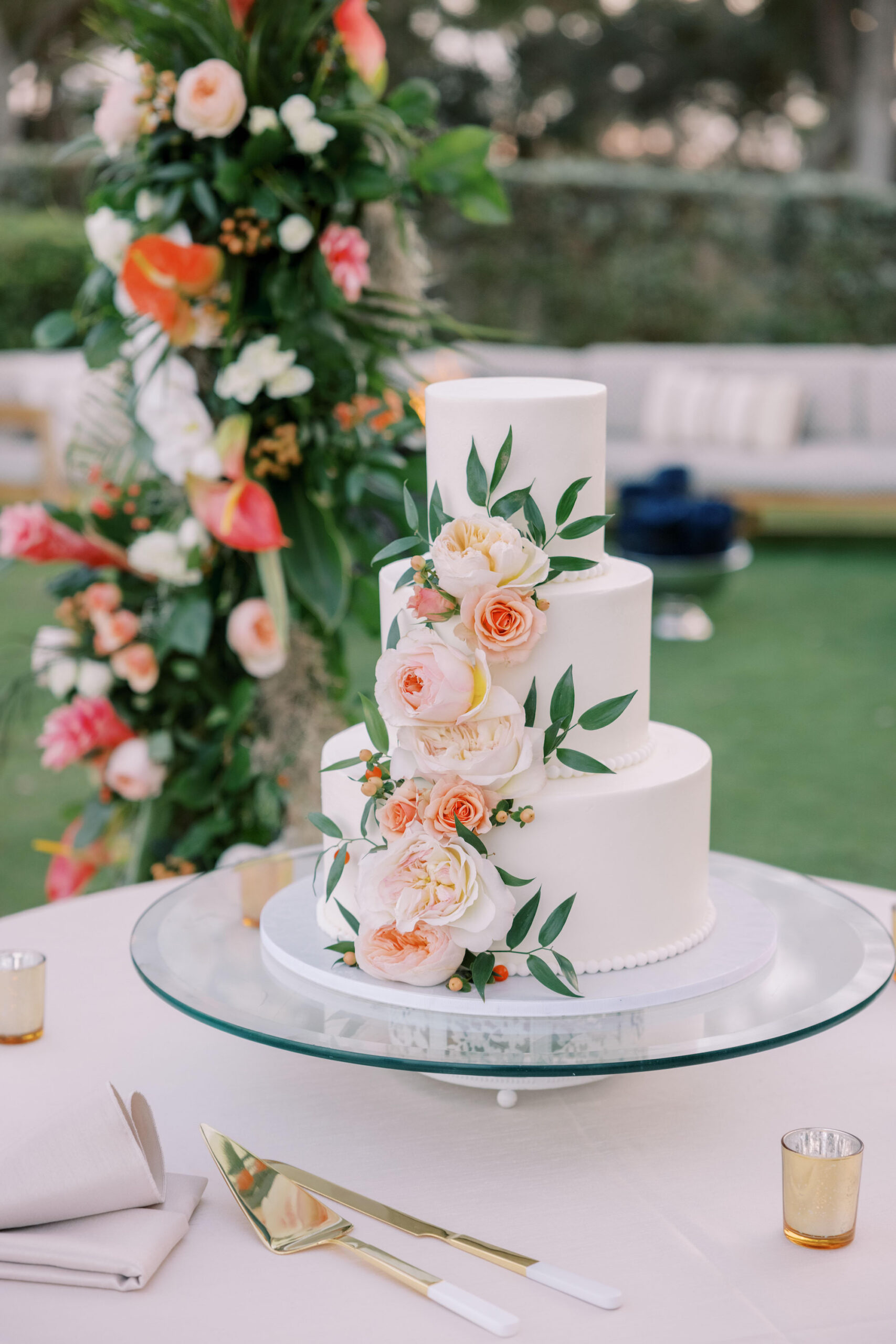 Pink and Orange Garden Rose Accents on White Three-tiered Buttercream Wedding Cake