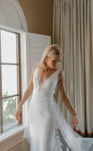 Bride Getting Ready Portrait with Deep V Illusion Crepe Wedding Dress Inspiration