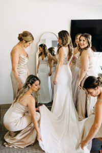 Bride and Bridesmaids Getting Ready Wedding Portrait | Matching Satin Champagne and Floor Length Dress Ideas | White Chiffon and Lace A-line Wedding Dress | Tampa Bay Hair and Makeup Artist Femme Akoi Beauty Studio | Boutique Truly Forever Bridal