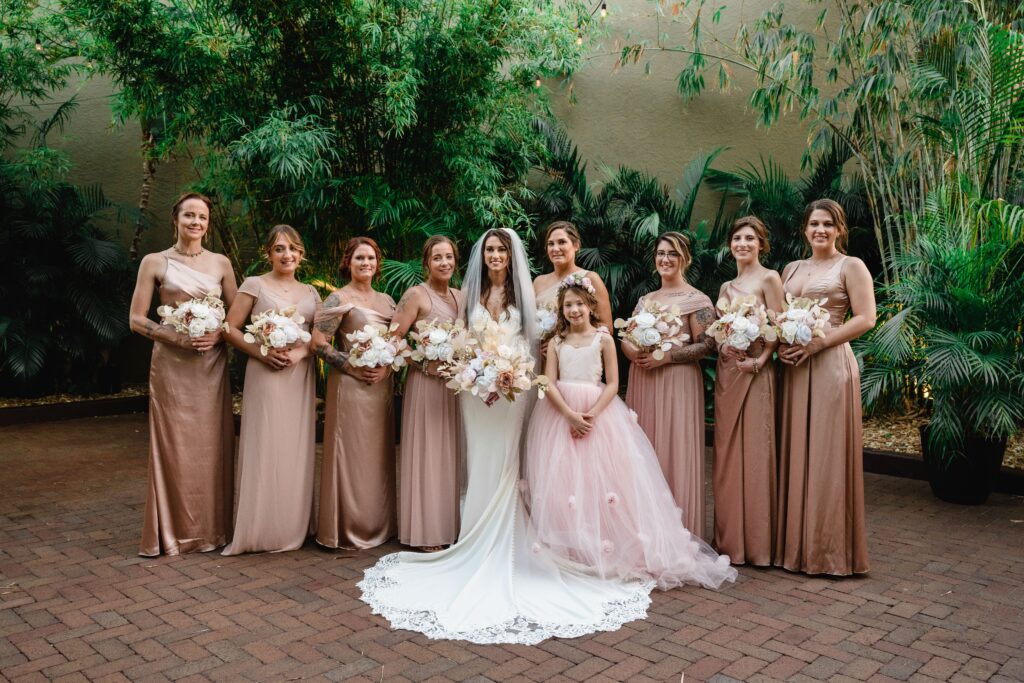 Bride with Bridesmaids in Mix and Match Blush Bridesmaids Dresses and Pink Ballgown Flower Girl Dresses Wedding Portrait