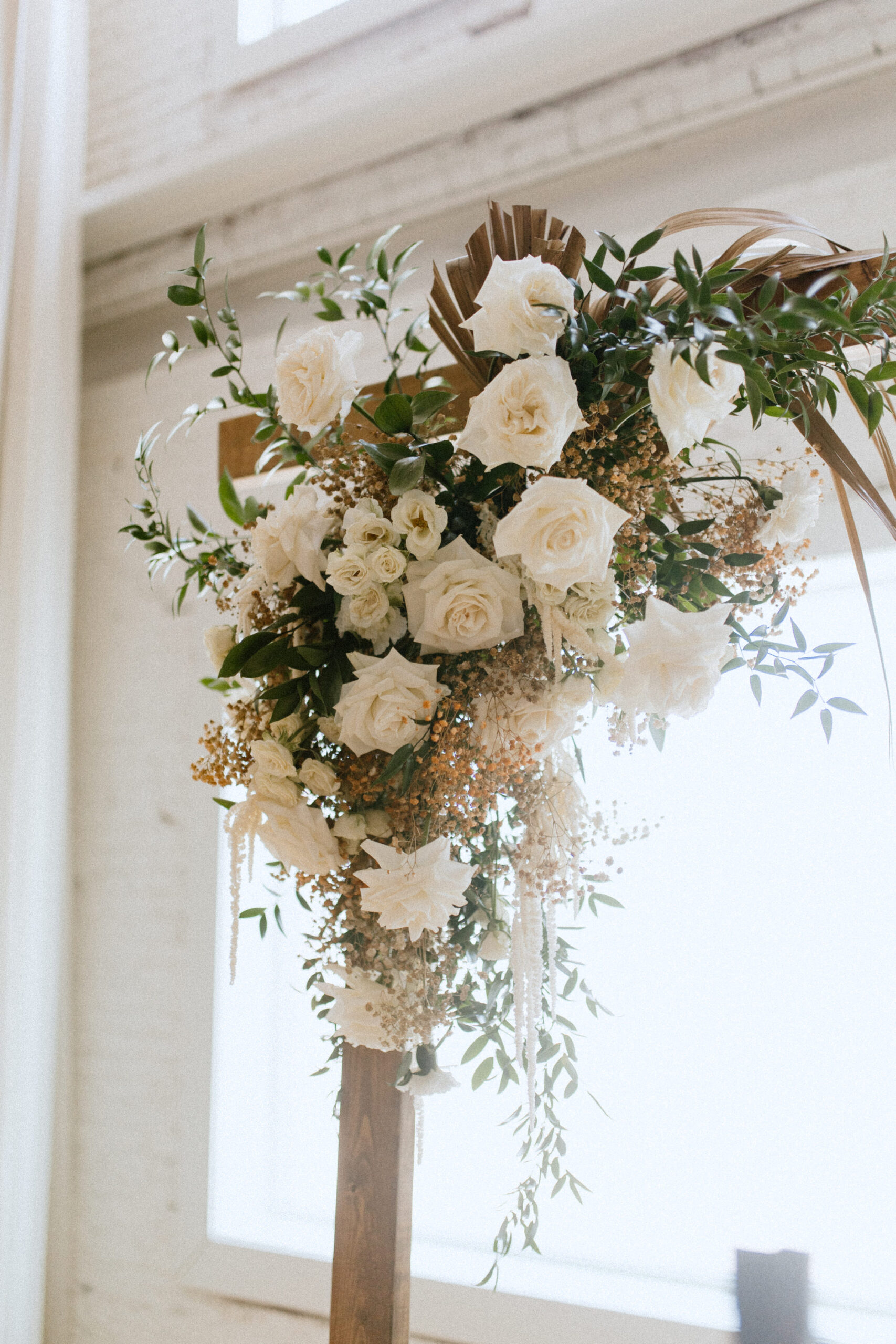 Elegant White and Cream Ceremony Florals with Greenery on Wooden Wedding Arch Inspiration