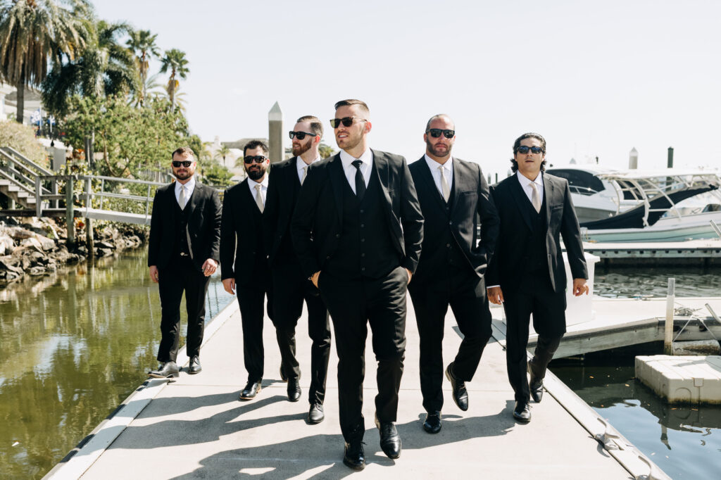 Groom with Groomsmen On Dock Wedding Portrait | Three-piece Black Suit with Champagne Ties Inspiration