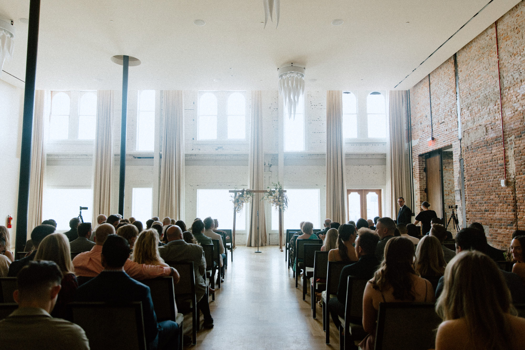 Elegant White and Cream Ceremony Florals with Greenery on Wooden Wedding Arch Inspiration