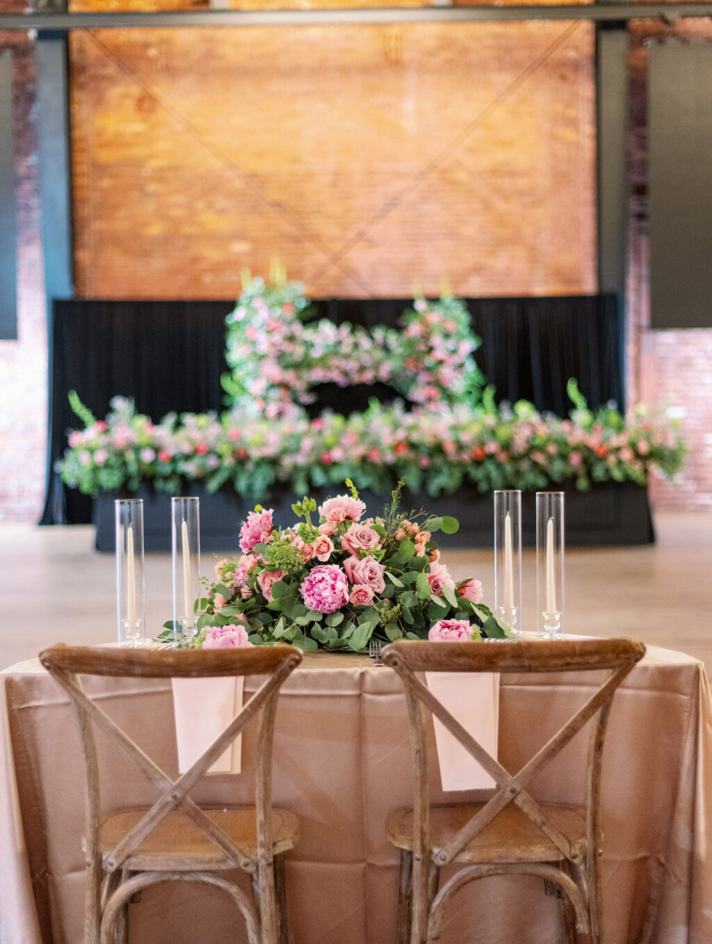 Crossback Wooden Chairs with Taper Candles in Hurricane Tubes Glass | Pink Roses and Greenery Centerpiece Wedding Reception Inspiration | Tampa Bay Rental A Chair Affair