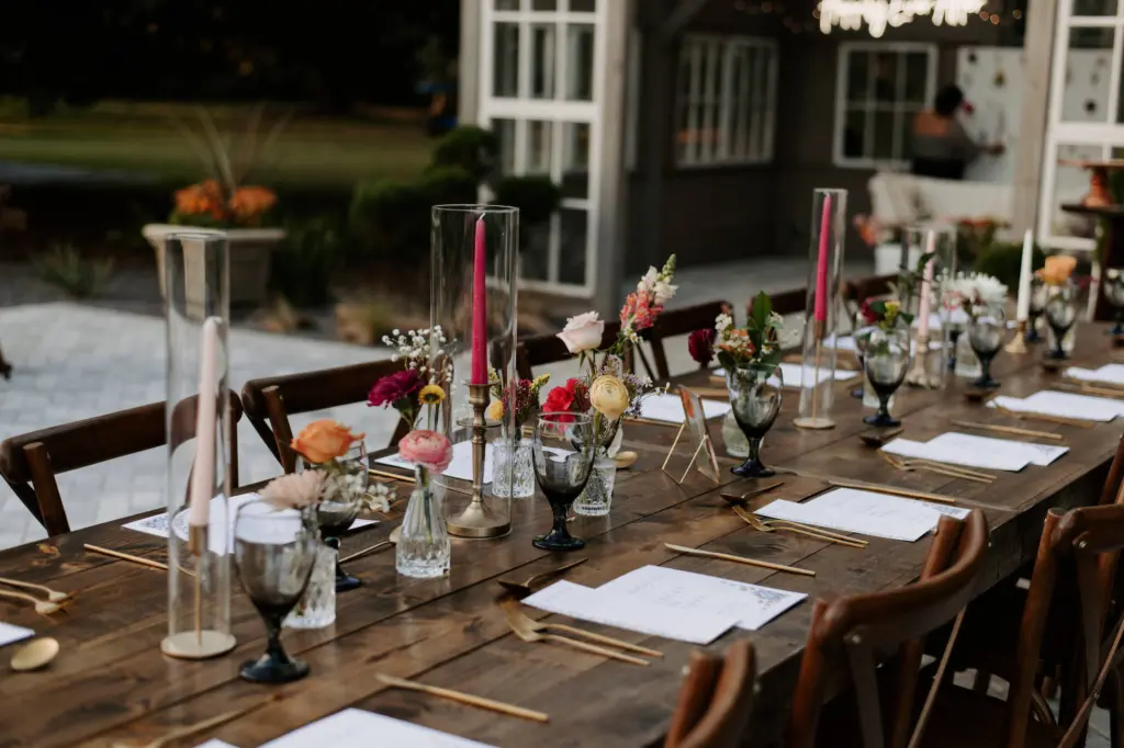 Garden Party Inspired Wedding Reception with Bright Pink Tapered Candles and Orange Florals at Wooden Tables Wedding Decor | Tampa Wedding Planner Stephany Perry Events | Caterer Elite Event Catering