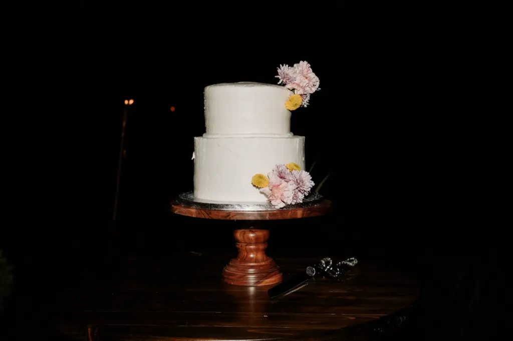 Simple Two Tiered Round White Wedding Cake with Subtle Floral Details