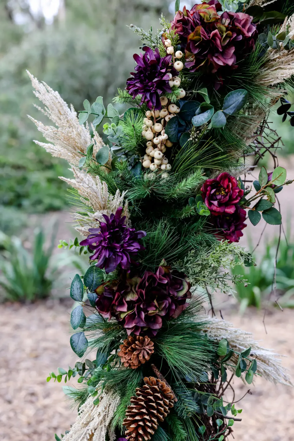 Woodsy Wedding Ceremony Arch Inspiration | Purple and Burgundy Flowers, Hypernicum Berries, Pinecones, and Greenery