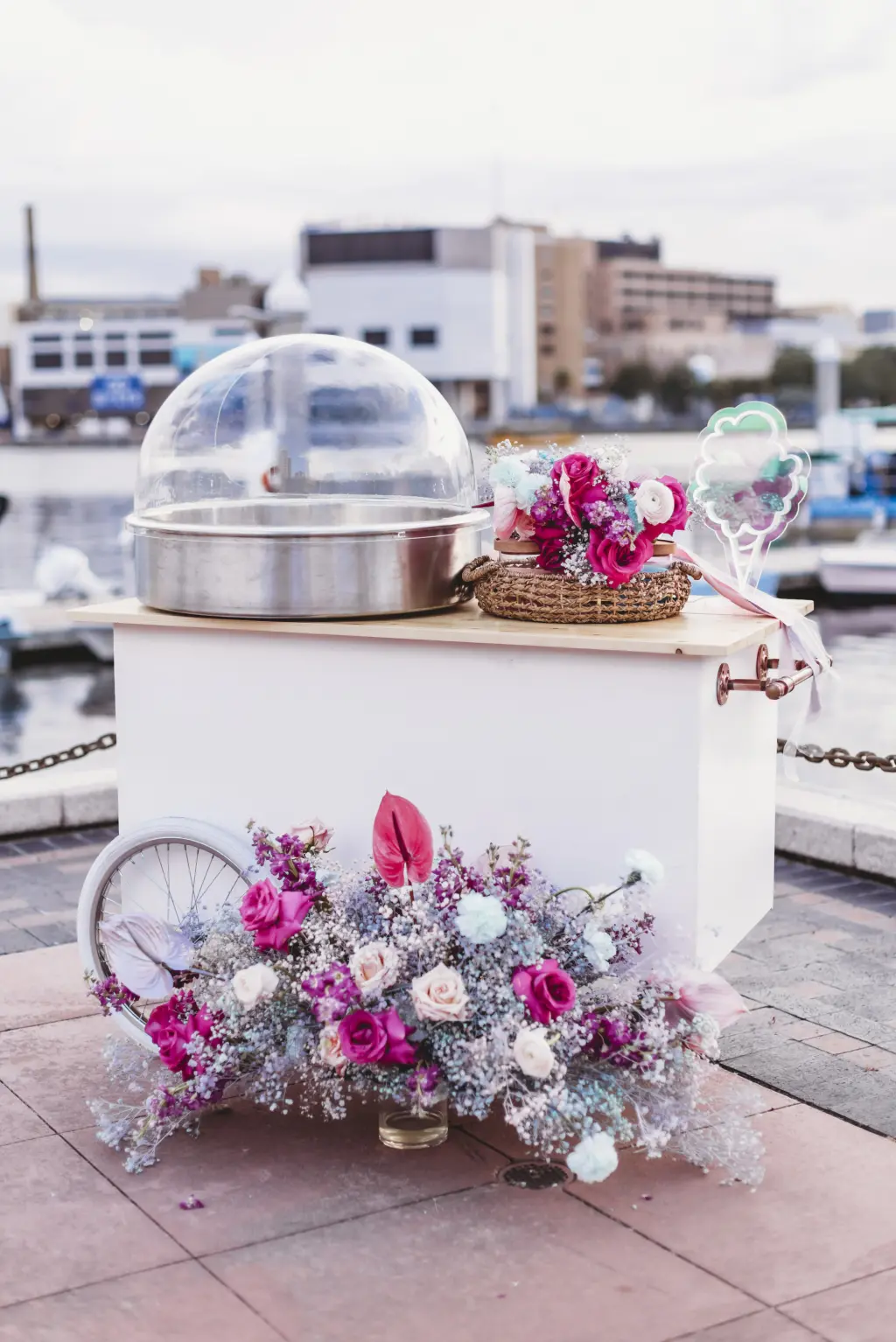 Cotton Candy Machine Decorated with Bright Pink and White Florals and Baby's Breath Wedding Reception Dessert Ideas