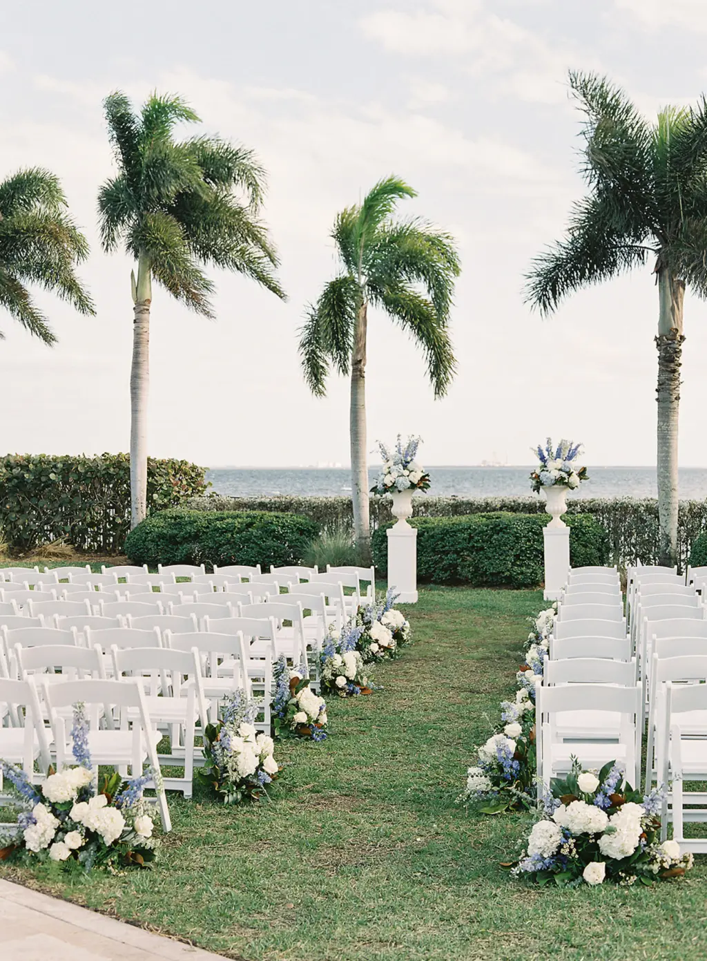 Folding White Garden Chairs | White Roses and Blue Hydrangea Aisle Flower Arrangements for Classic Waterfront Wedding Ceremony | South Tampa Venue | Tampa Yacht and Country Club | Florist Save The Date Florida