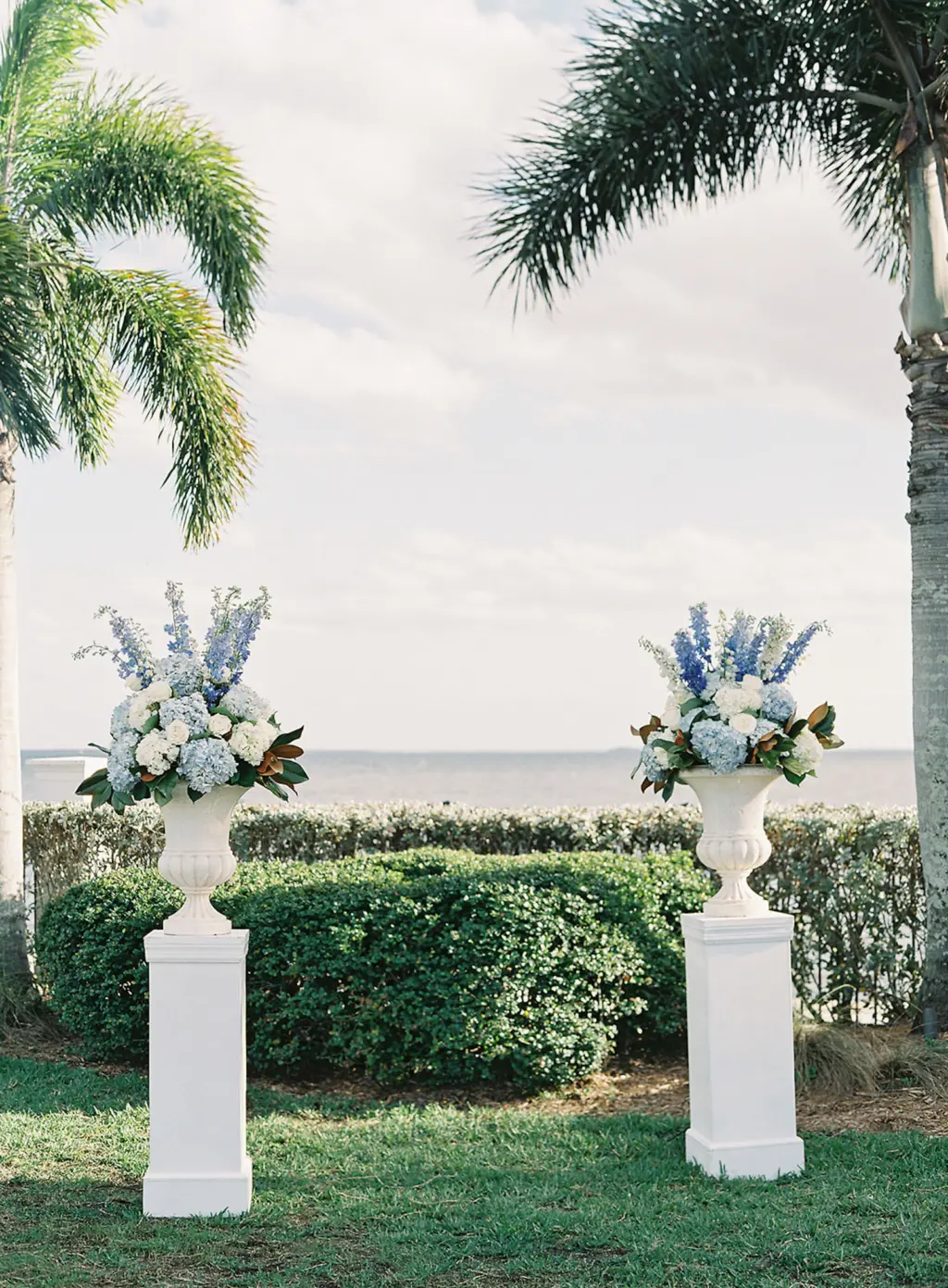 White Classic Vases with Blue Stock Flowers, Hydrangeas, and Greenery for Wedding Ceremony Altar | Tampa Bay Florist Save The Date Florida