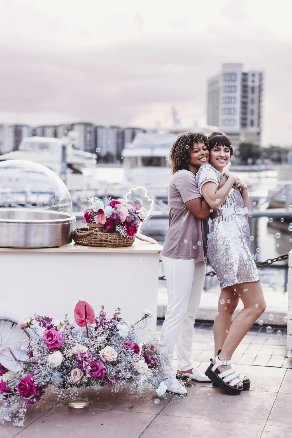 Same Sex Couple at Intimate Elopement with Cotton Candy Machine Decorated with Bright Pink Florals and Baby's Breath Wedding Decor Inspiration | Tampa Wedding Planner Wilder Mind Events