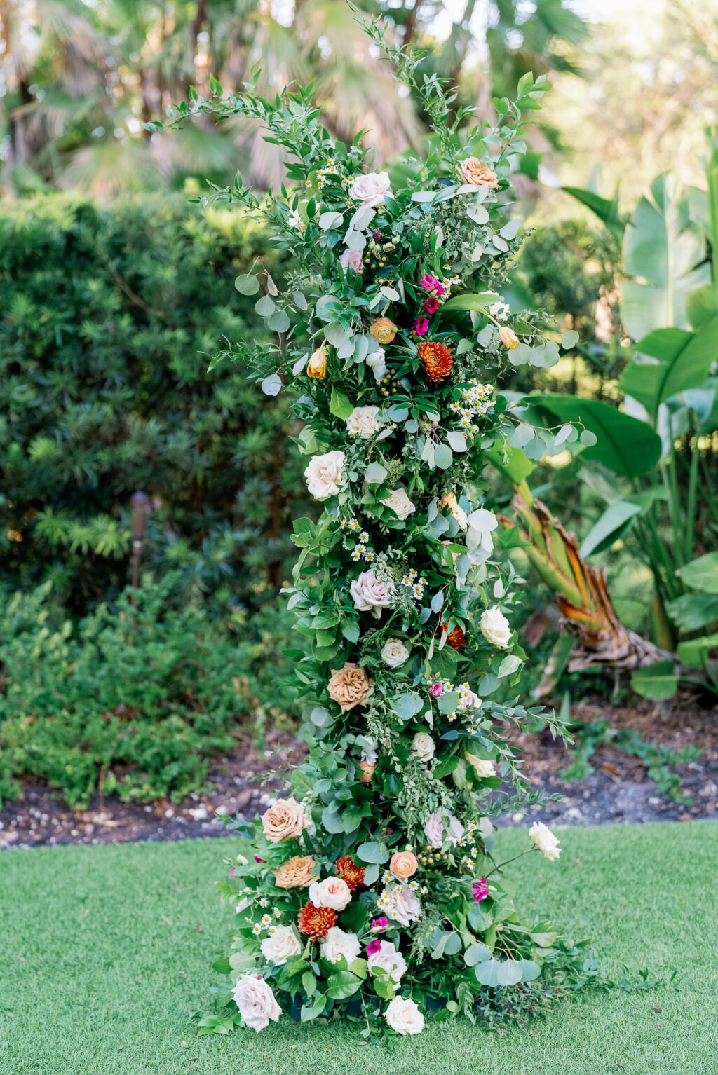 Asymmetrical Orange Crysanthemum, White Roses, and Greenery Flower Stand for Altar Inspiration | Gold Chiavari Chairs for Garden Wedding Ceremony Ideas