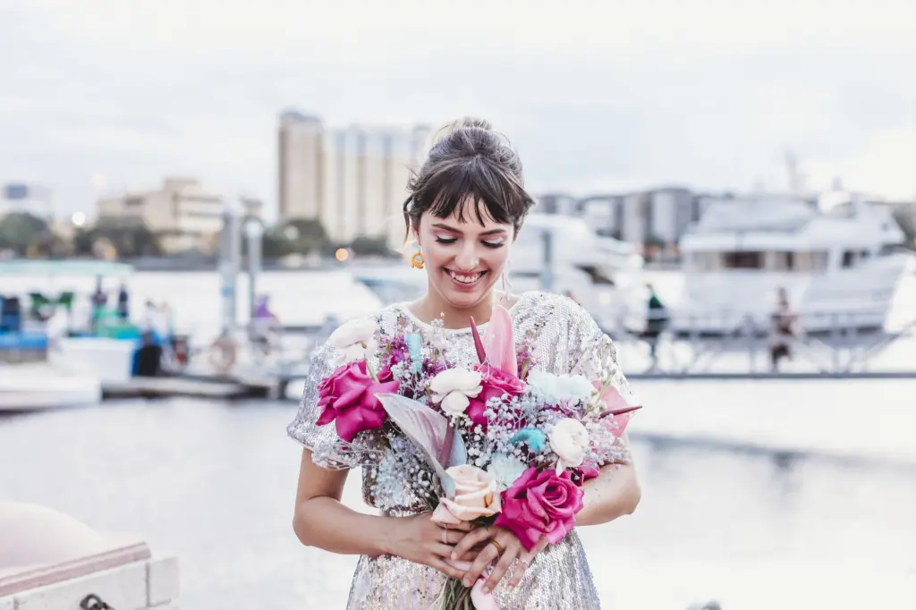 Bride in Sequin Mini Wedding Dress Holding Vibrant Wedding Bouquet Portrait | Bright Pink, Blue, and Baby's Breath Wedding Bouquet Inspiration | Tampa Wedding Planner Wilder Mind Events