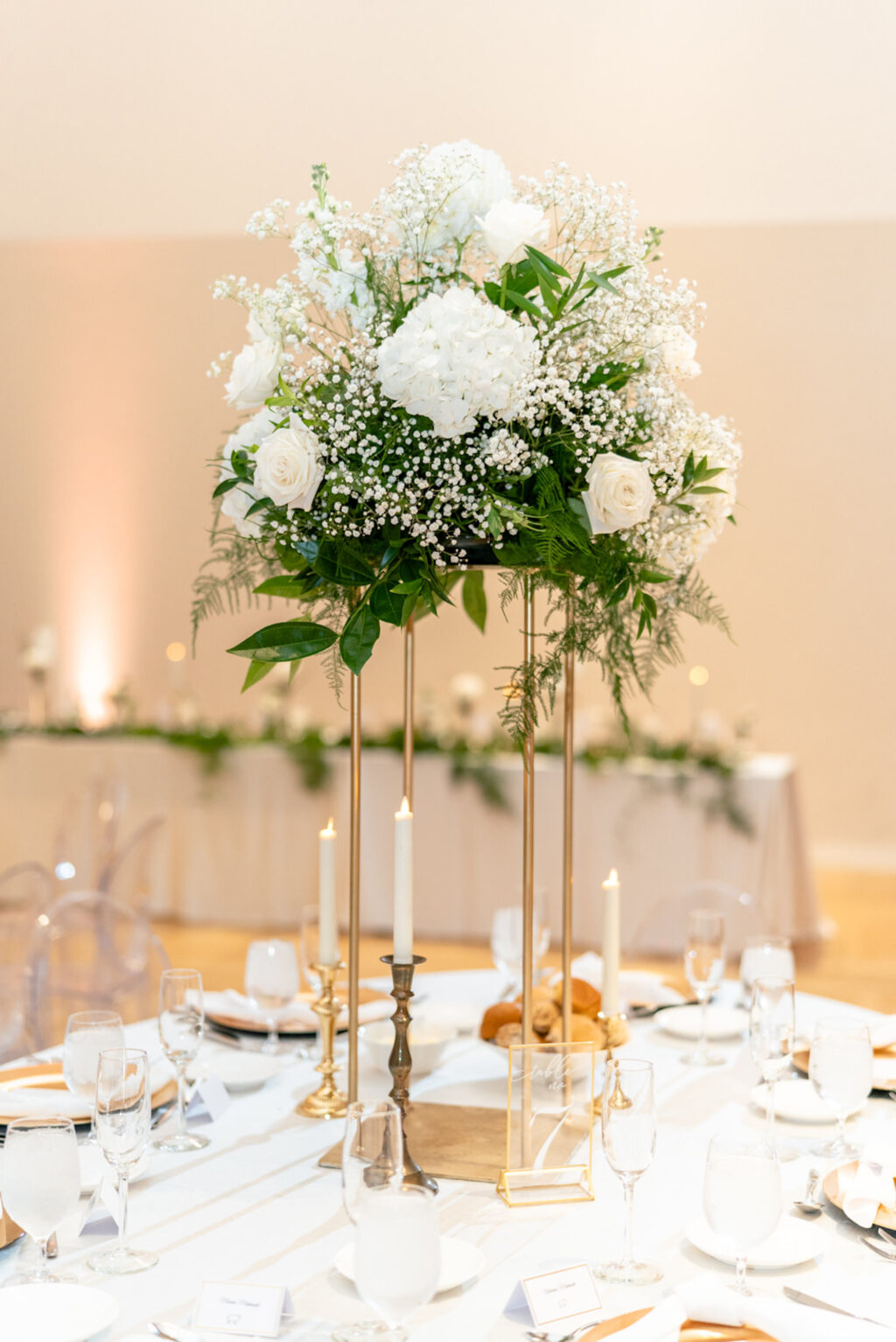 Tall Gold Flower Stand with Hydrangeas, White Roses, and Baby's Breath Centerpiece Ideas | White and Gold Wedding Reception Table Setting Inspiration