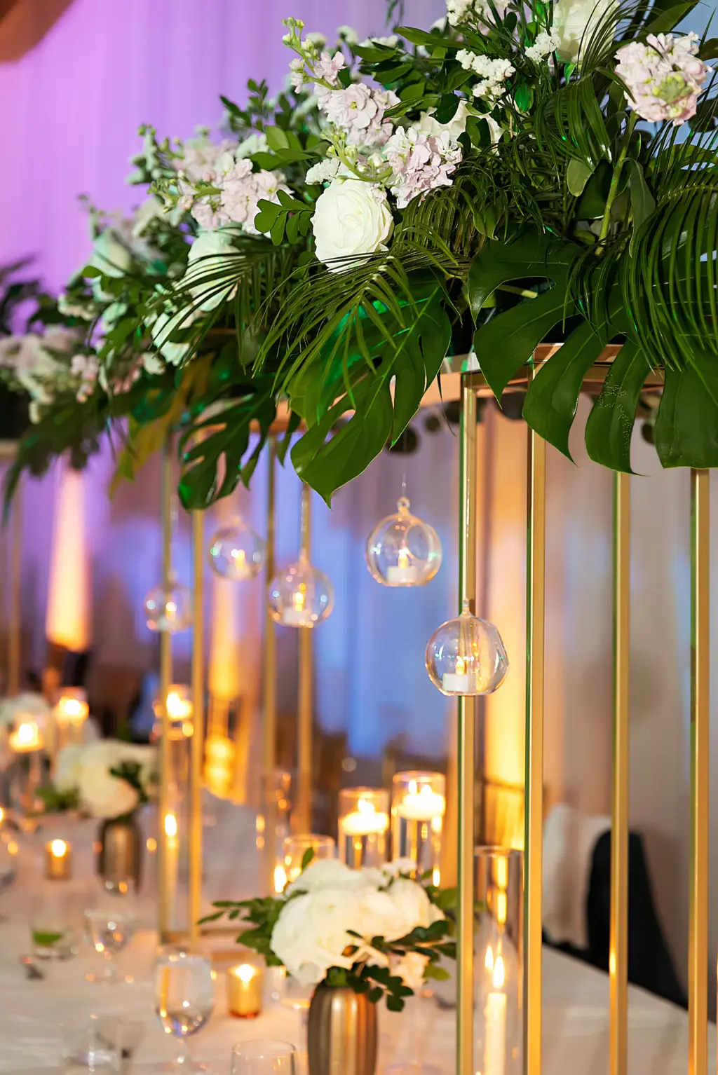 Classic Elegant Tall Gold Flower Stand Centerpiece Inspiration with Hanging Tea Light Candles, Monstera, Palms, White Roses and Hydrangeas | Wedding Reception Ideas