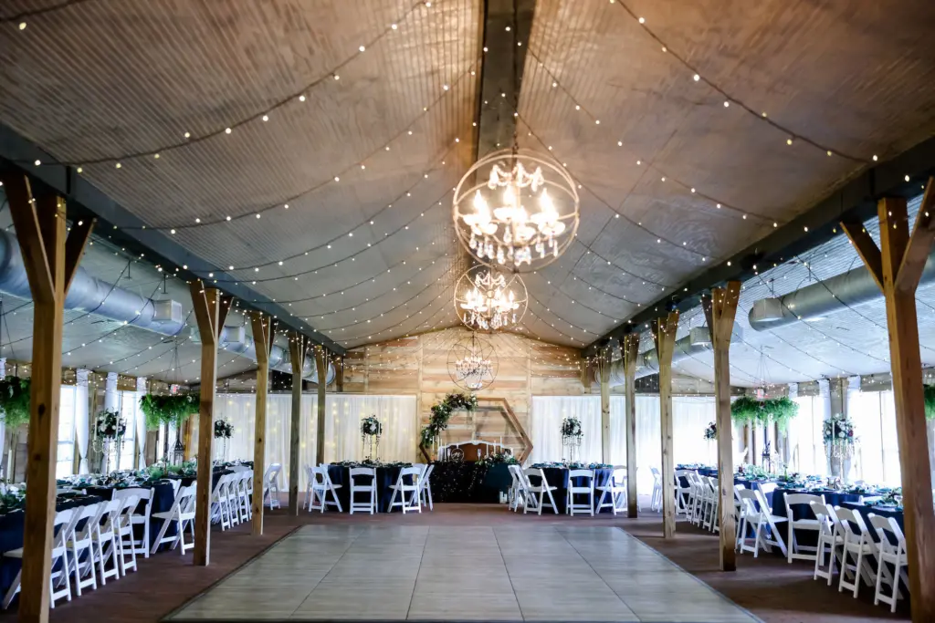 Rustic Wedding Reception Inspiration | Hexagon Wooden Arch Backdrop for Sweetheart Table | Folding Garden Chairs Seating Inspiration | Carriage House Stable at Tampa Bay Venue Cross Creek Ranch