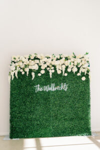 White Rose and Wisteria Greenery Backdrop with Custom Neon Sign Wedding Reception Guest Entertainment Ideas