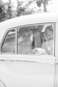 Bride and Groom Leaving Wedding Ceremony | Antique Car Transportation