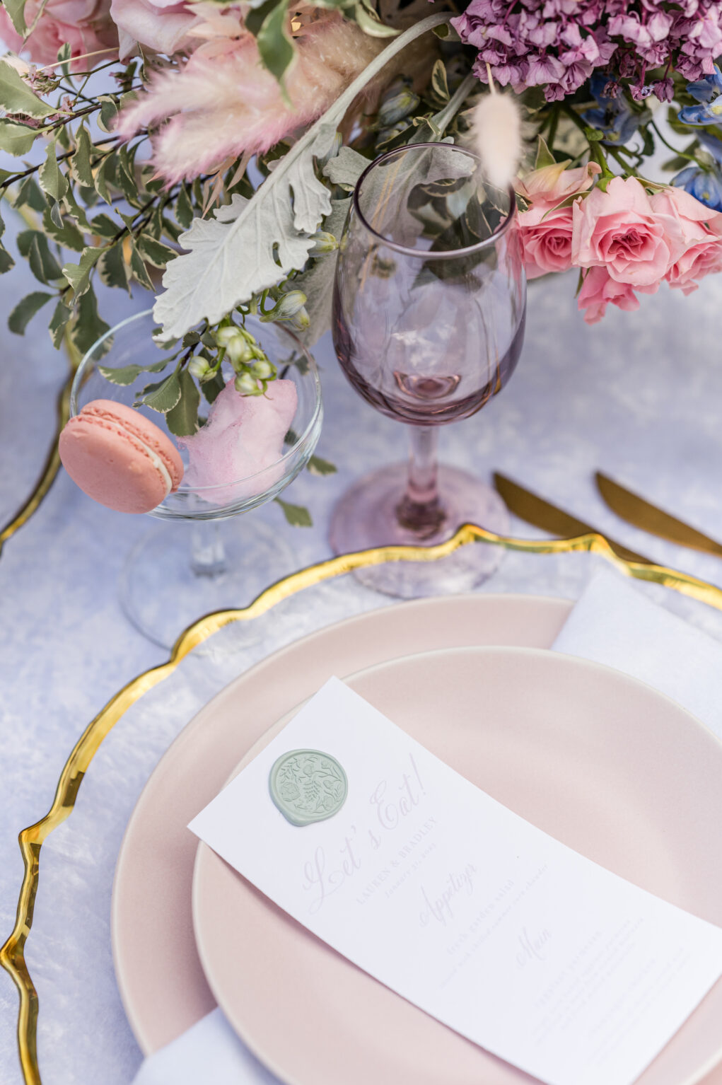 Macaron and Cotton Candy Cocktail Wedding Reception Treat Ideas | Purple Colored Glassware, Gold-rimmed Chargers and Blush Pink Plates Inspiration