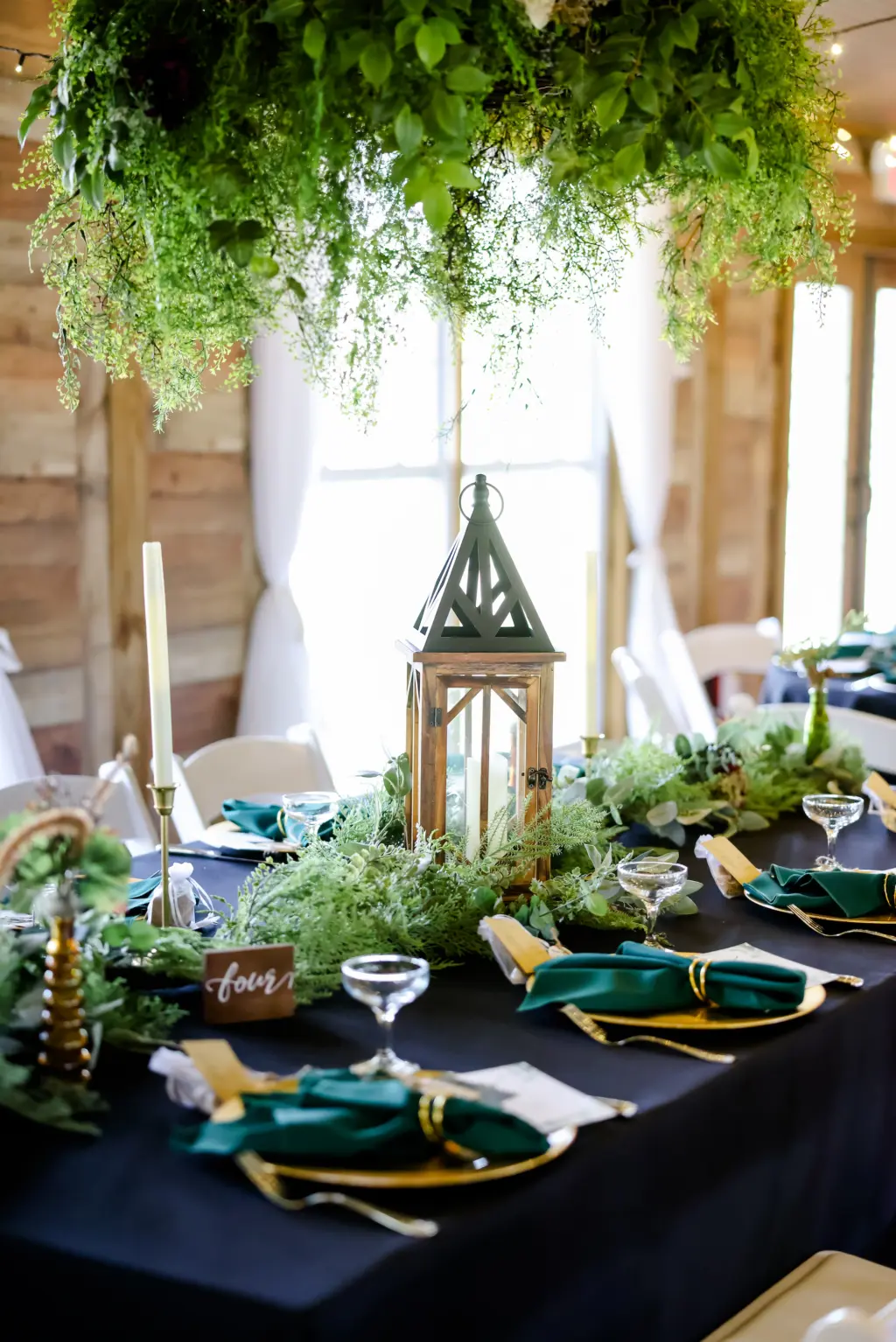 Hanging Greenery Chandelier with Dark Green Linen and Gold Chargers | Earthy Wedding Reception Inspiration