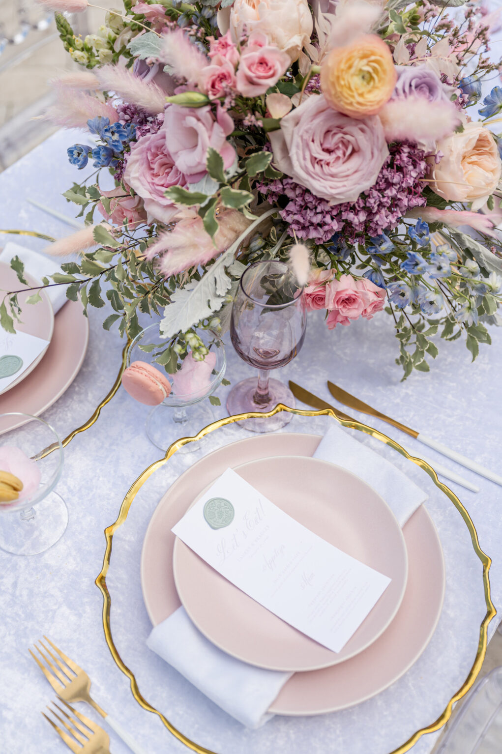 Spring Garden Purple, Orange and Pink Roses, Blue Stock Flowers, and Greenery Centerpieces | Gold Flatware with Gold-rimmed Chargers and Blush Plate | Whimsical Garden Wedding Reception Inspiration | Sarasota Planner MDP Events | Florist Save The Date Florida