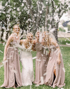 Bride and Bridesmaids with Glitter Confetti Cannons Wedding Portrait | Neutral Taupe Dusty Rose Bridesmaids Dress Inspiration | Photographer Dewitt for Love Photography | Videographer Shannon Kelly Films