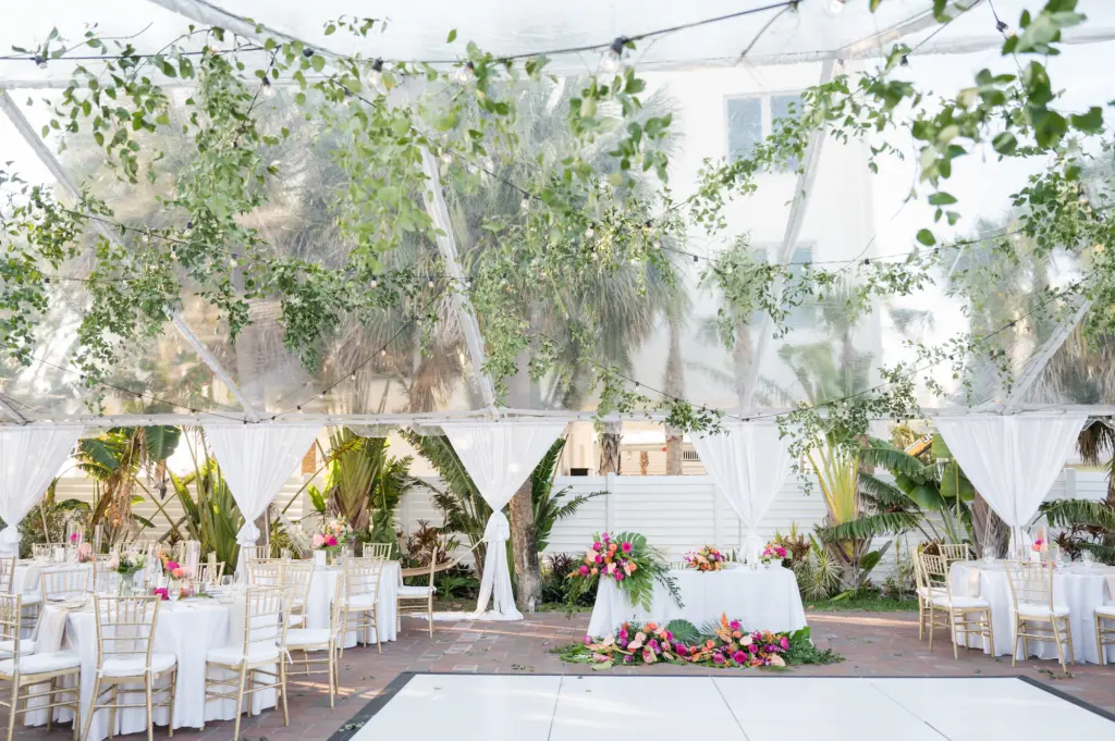 Tented Tropical Beach Wedding Reception Ideas with Greenery and Pops of Color | White Dance Floor with Sweetheart Table | Sarasota Florist Save the Date Florida
