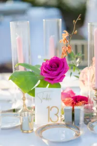 Hot Pink and Orange Floral Centerpieces with Monstera and Greenery Detailing Centerpiece Inspiration and Acrylic White and Gold Table Numbers | Sarasota Florist Save the Date Florida