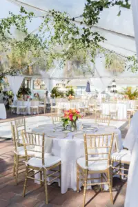Tented Tropical Beach Wedding Reception Ideas with Greenery and Pops of Color | Gold Chiavari Chairs with White Linen Rounds | Wedding Planner MDP Events Tampa Florida