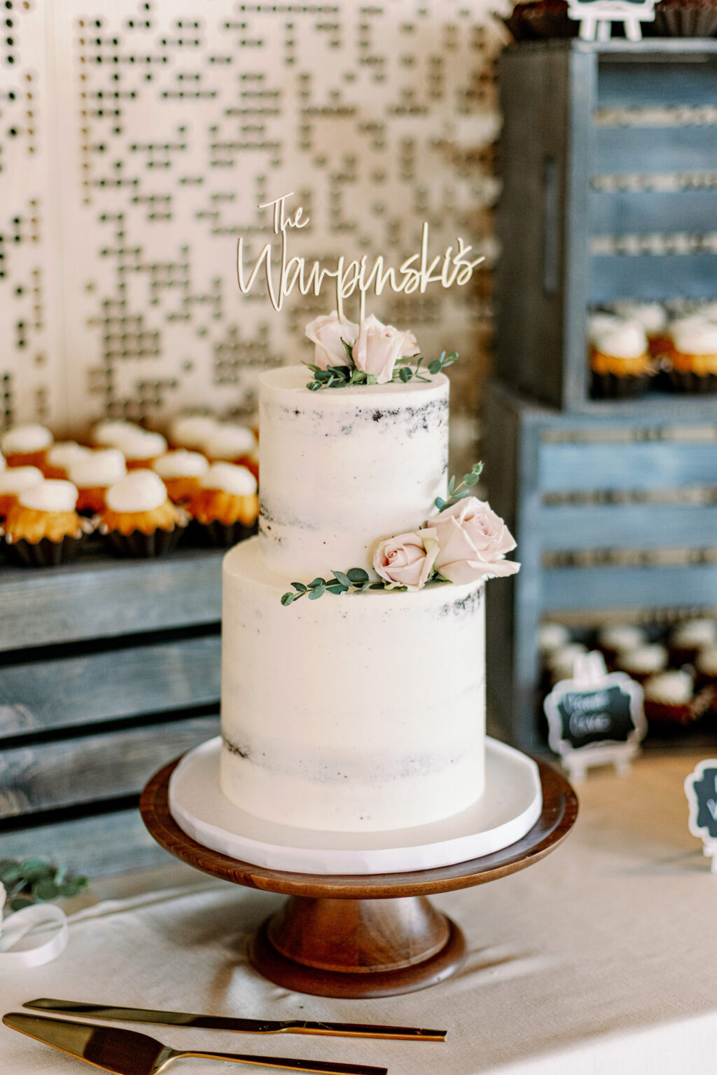 Two-tiered Semi-Naked Wedding Cake with Blush Roses and Greenery Accents | Personalized Name Cake Topper | Tampa Bay Cake Company