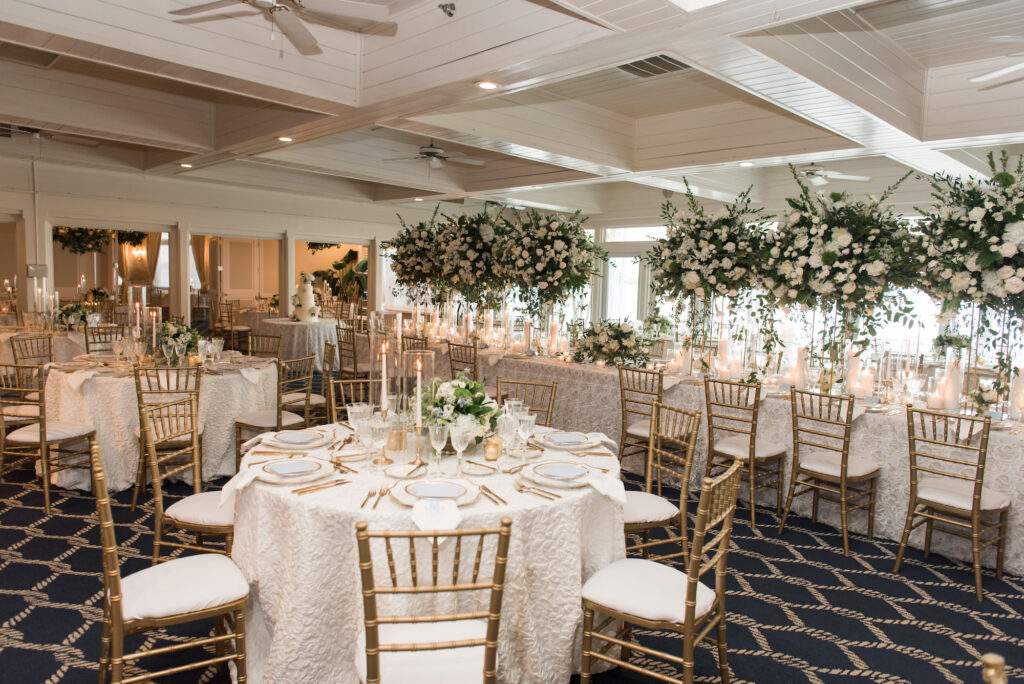 Tall Gold Flower Stand with White Flowers and Greenery Centerpiece Ideas | Gold Chiavari Chairs | Timeless Candlelit Wedding Reception | Tampa Bay Rentals A Chair Affair | Kate Ryan Event Rentals | Planner Parties A La Carte