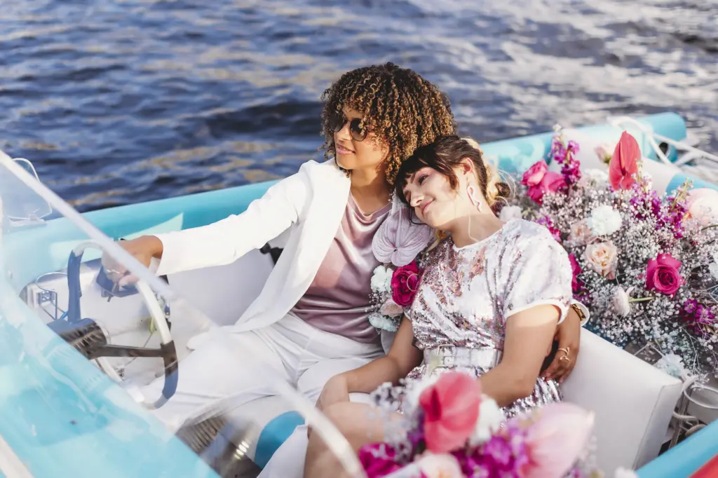 Funky Same Sex Wedding Couple Boat Portrait with Bright Pink Bouquet Inspiration on the Tampa Bay | Tampa Wedding Planner Wilder Mind Events