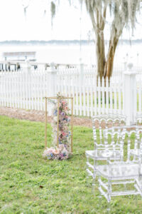 Waterfront Pastel Wedding Ceremony Inspiration | Clear Acrylic Chairs | Gold Cascading Flower Stand for Altar Ideas | Tampa Bay Florist Save The Date Florida