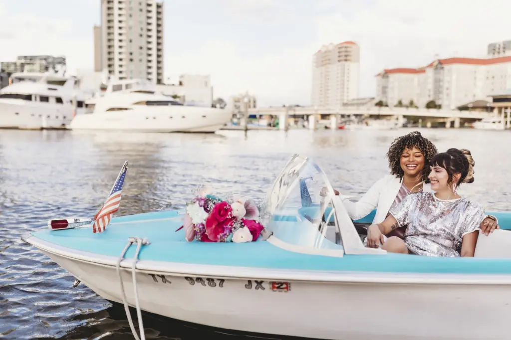 Same Sex Wedding Couple Boat Portrait with Bright Floral Inspiration in Downtown Tampa | Planner Wilder Mind Events