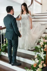 Bride and Groom First Look Wedding Portrait on Staircase with Peach and Cream Florals in Greenery | Tampa Florida Wedding Portrait Mary Anna Photography
