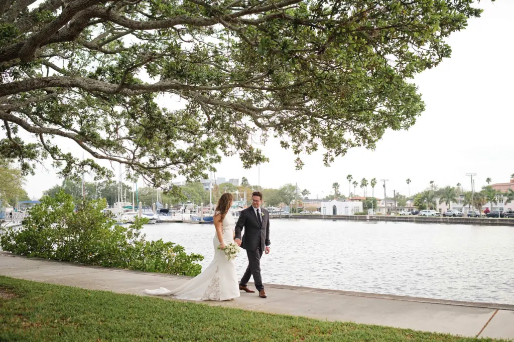 Bride and Groom Walking by the Water Wedding Portrait | Venue Davis Island Garden Club