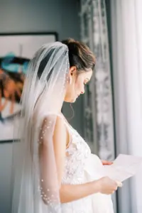 Bride Reading Letter from Groom Wedding Portrait | Pearl Veil Ideas