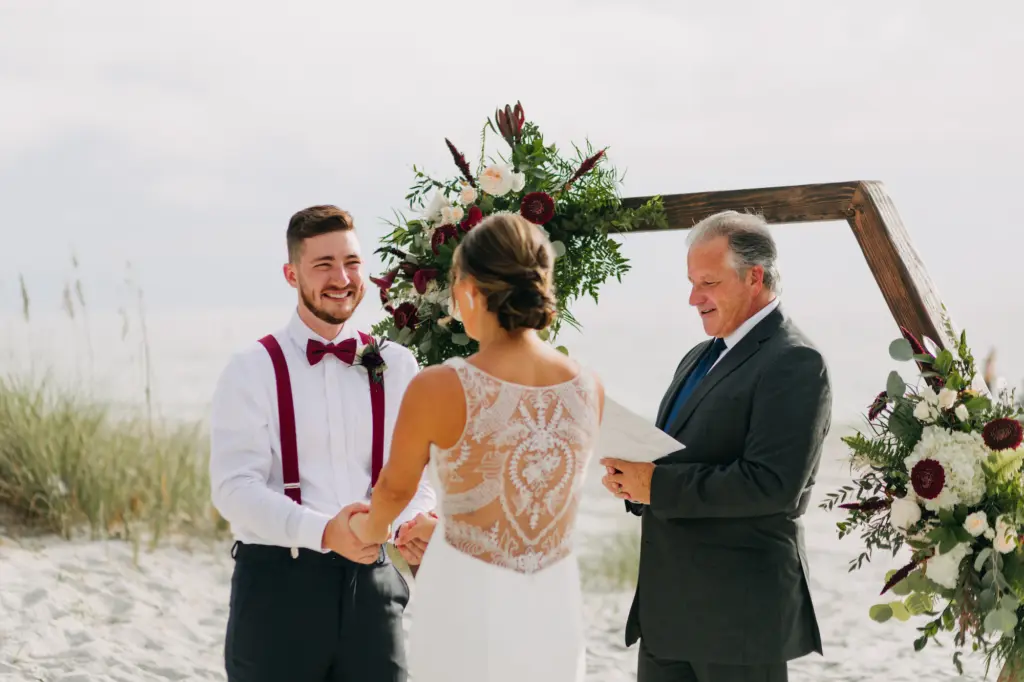 Bride and Groom Vow Exchange | Wooden Hexagon Wedding Ceremony Backdrop with Burgundy Scabiosa, Roses, White Hydrangeas, and Greenery Fall Flower Arrangment Ideas