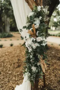 Wooden Arch Wedding Ceremony Backdrop | White Drapery with Blush Roses, Pampas Grass, and Greenery | Outdoor Oak Tree Wedding Inspiration | Tampa Bay Florist Monarch Events and Design