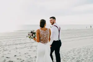Bride and Groom Walking on the Beach | Fall Beach Wedding Elopement Ideas | Tampa Bay Planner Elope Tampa Bay | Photographer Amber McWhorter Photography