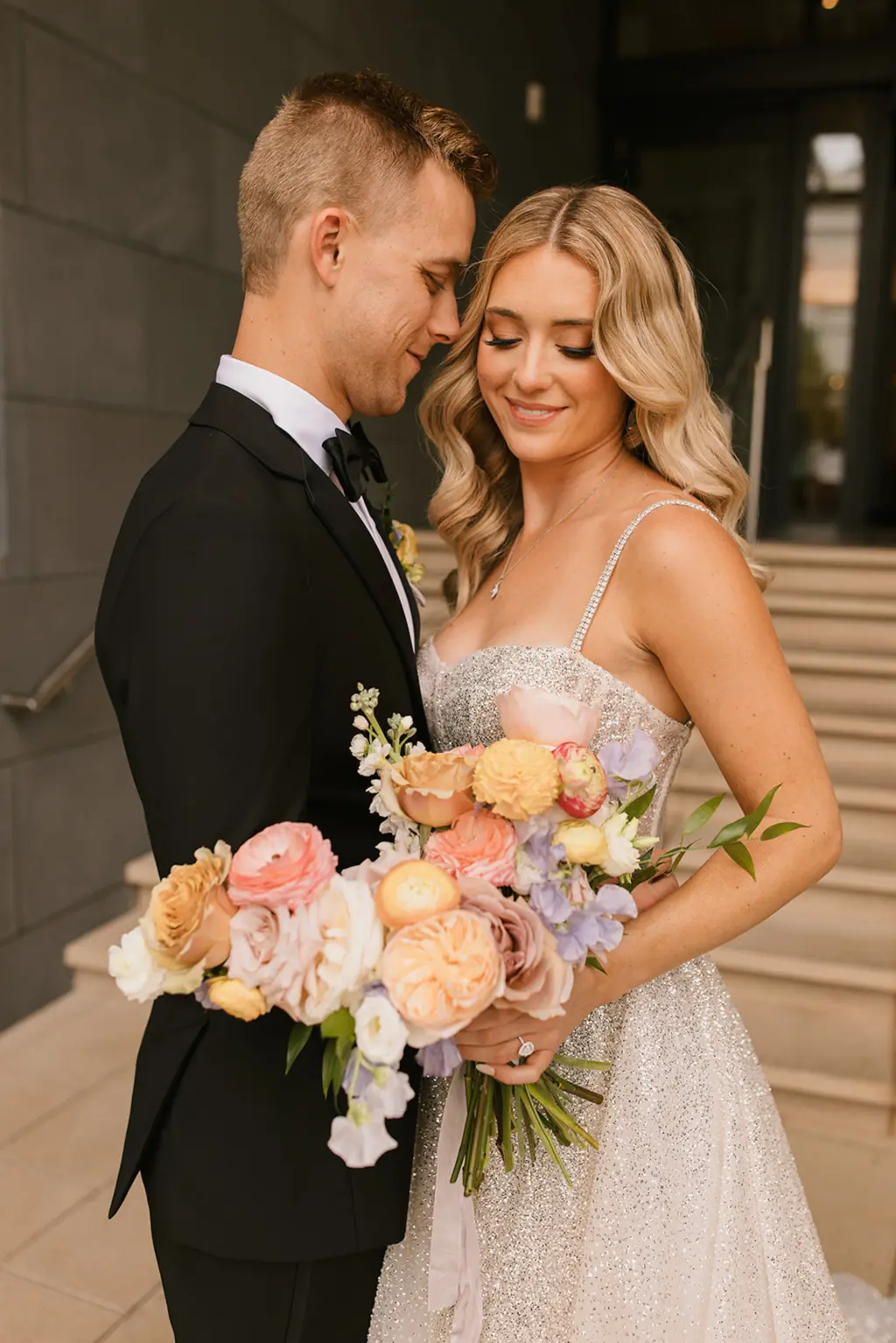 Spring Wedding Bridal Bouquet Inspiration with Pastel Orange and Pink Roses, Greenery, and Ranunculus | Bridal Hair and Makeup by Tampa Bay HMUA Femme Akoi Beauty Studio | Tampa Planner Coastal Coordinating