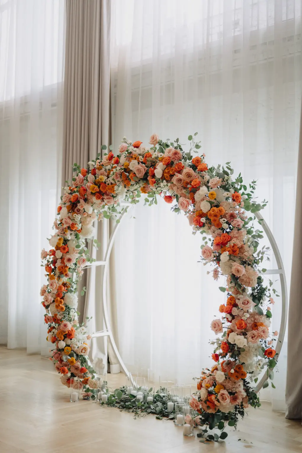 Pink Roses, Orange Carnations, White Hydrangeas, and Greenery for Circular Arch | Spring Wedding Ceremony Decor Ideas