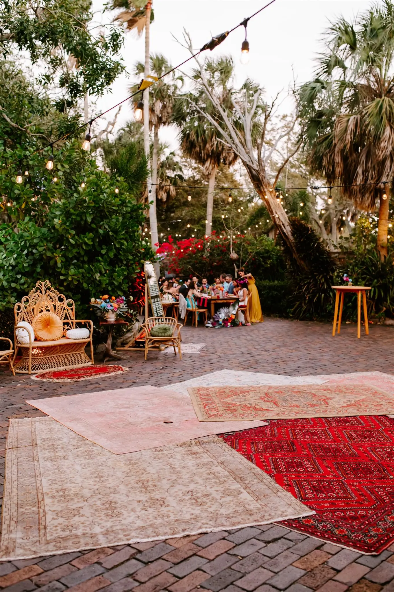 Boho Outdoor Wedding Reception with Red, Orange, and Beige Rugs Decor Ideas | St Pete Event Planner Wilder Mind Events