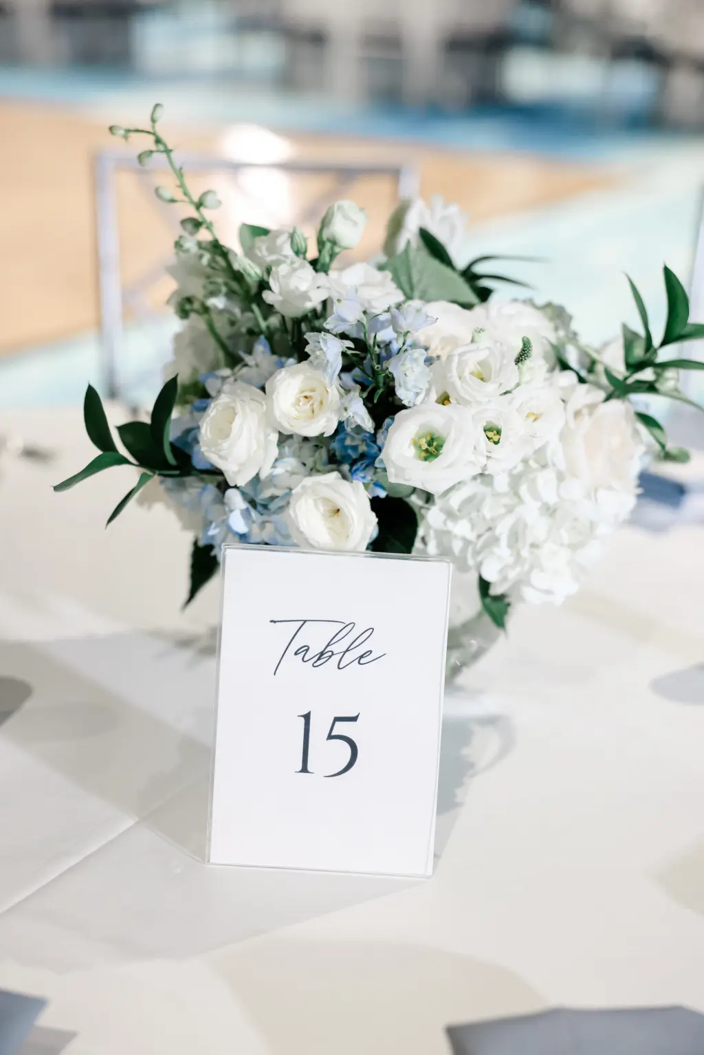 White Table Number Card Ideas | White Roses, Blue Hydrangeas, and Greenery Centerpiece Inspiration