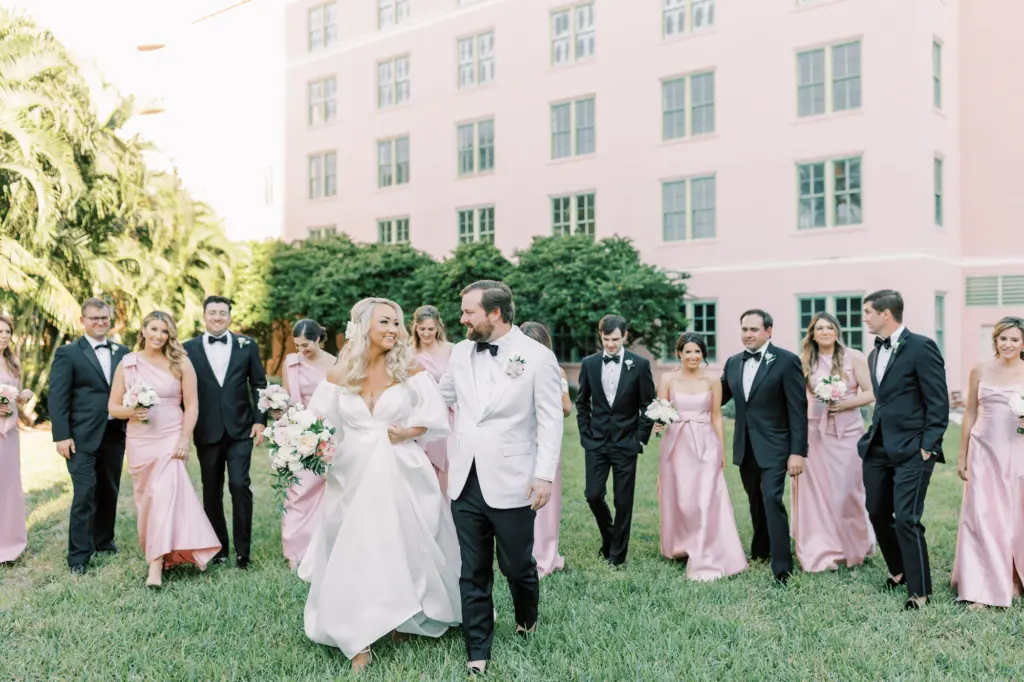 Bride and Groom with Wedding Party | Pink Satin Bridesmaids Dress Ideas | Groomsmen Black Tuxedos and Bowties Inspiration