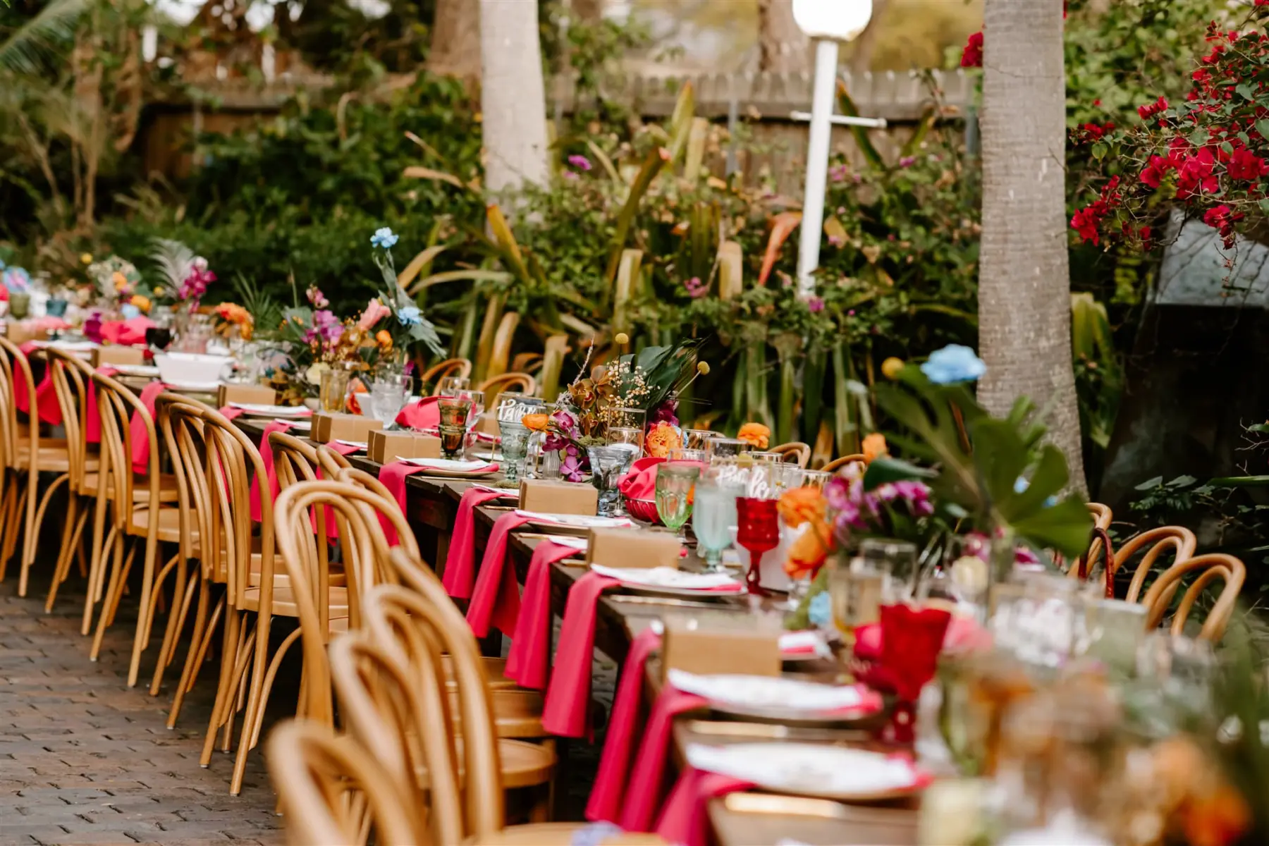 Vibrant Tropical Spring Outdoor Wedding Reception Curved Feasting Table Ideas | Tampa Bay Event Planner Wilder Mind Events
