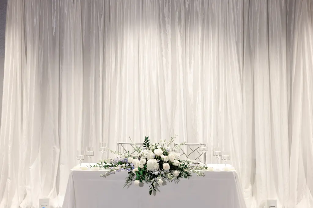 White Roses, Hydrangeas, Stock Flowers, and Greenery Tabletop Flower Arrangement for Wedding Reception Sweetheart Table Inspiration
